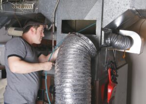 technician-cleaning-out-air-duct